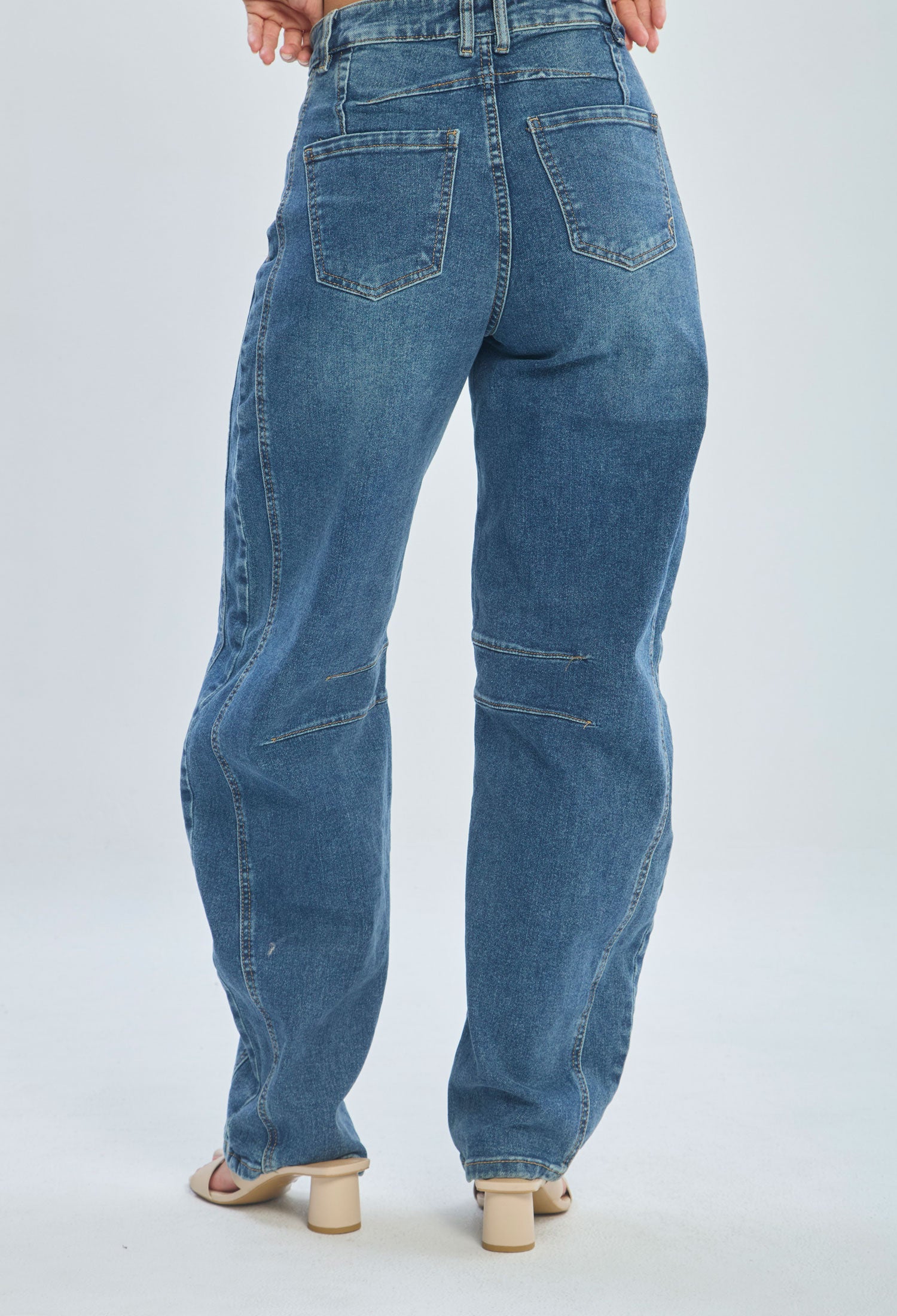 Women's wide-leg blue jeans with back pockets, styled with beige heeled sandals