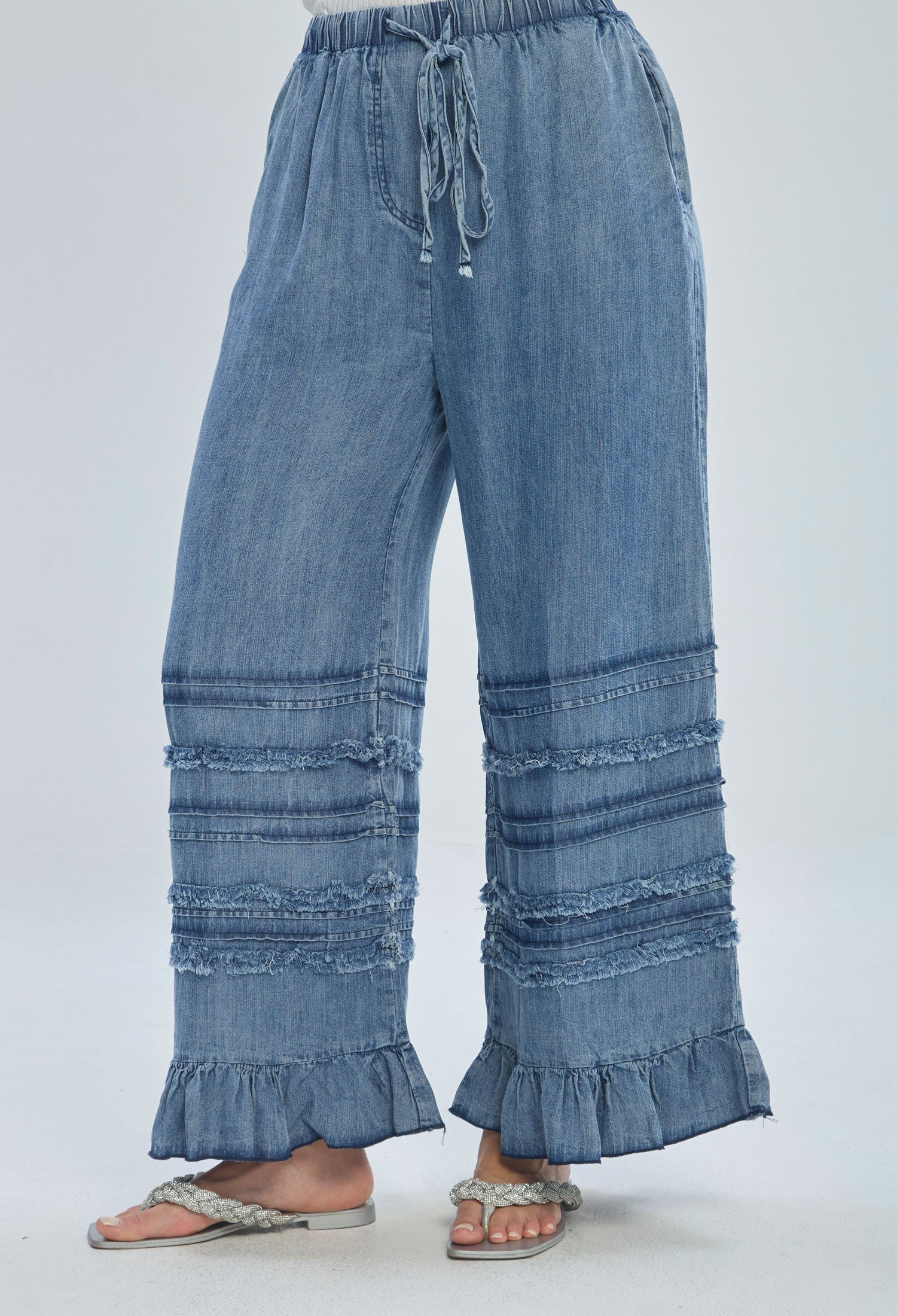 Wide leg denim pants with frayed trim, ruffle hem, and drawstring waist for women