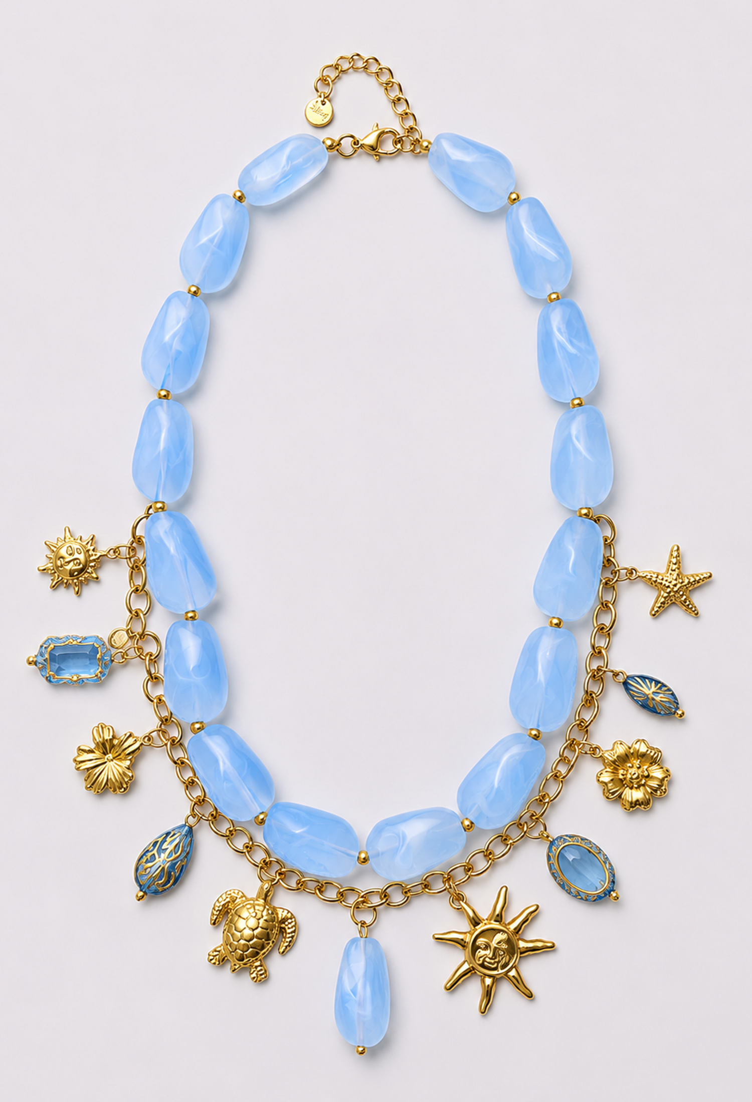 Collar statement de piedras marmoladas con cadena y dijes dorados de sol, estrella de mar y tortuga - Azules