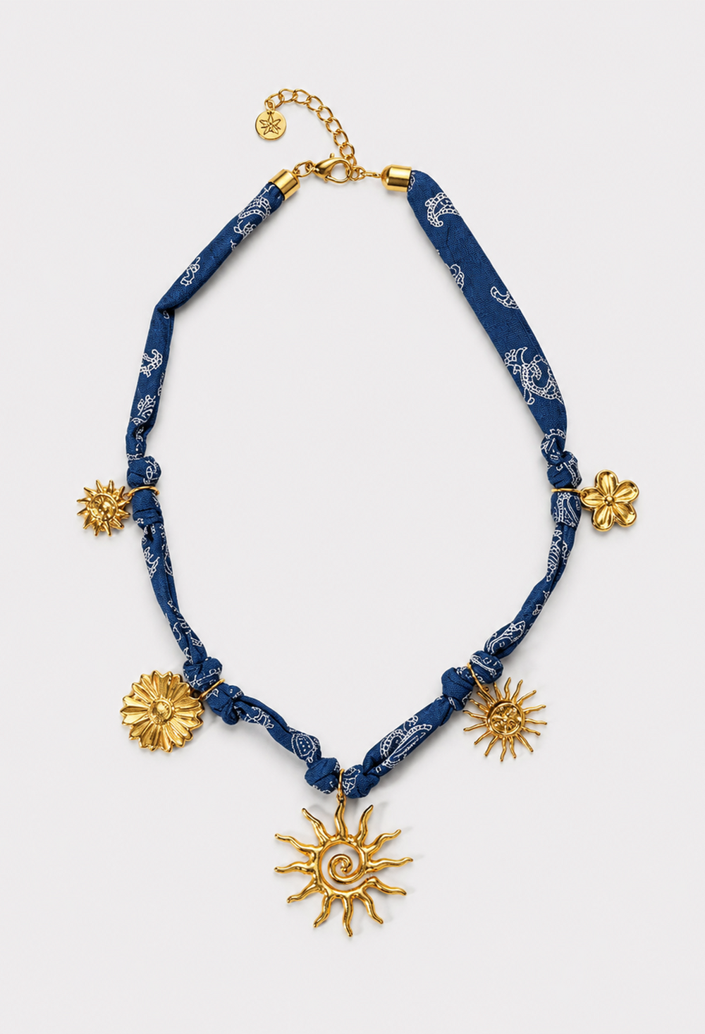 Collar de pañuelo azul índigo estampado con dijes dorados de soles y flores