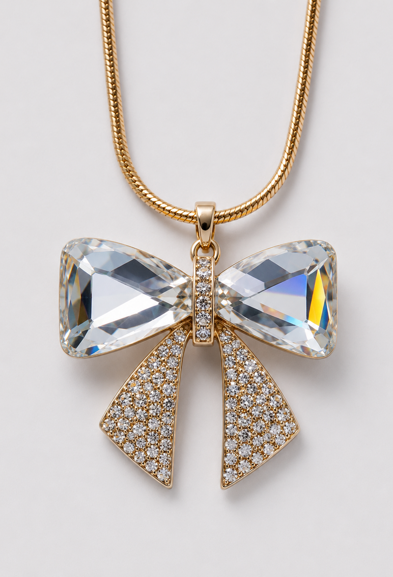 Collar largo dorado con dije de lazo en cristales facetados y pedrería - vista 2
