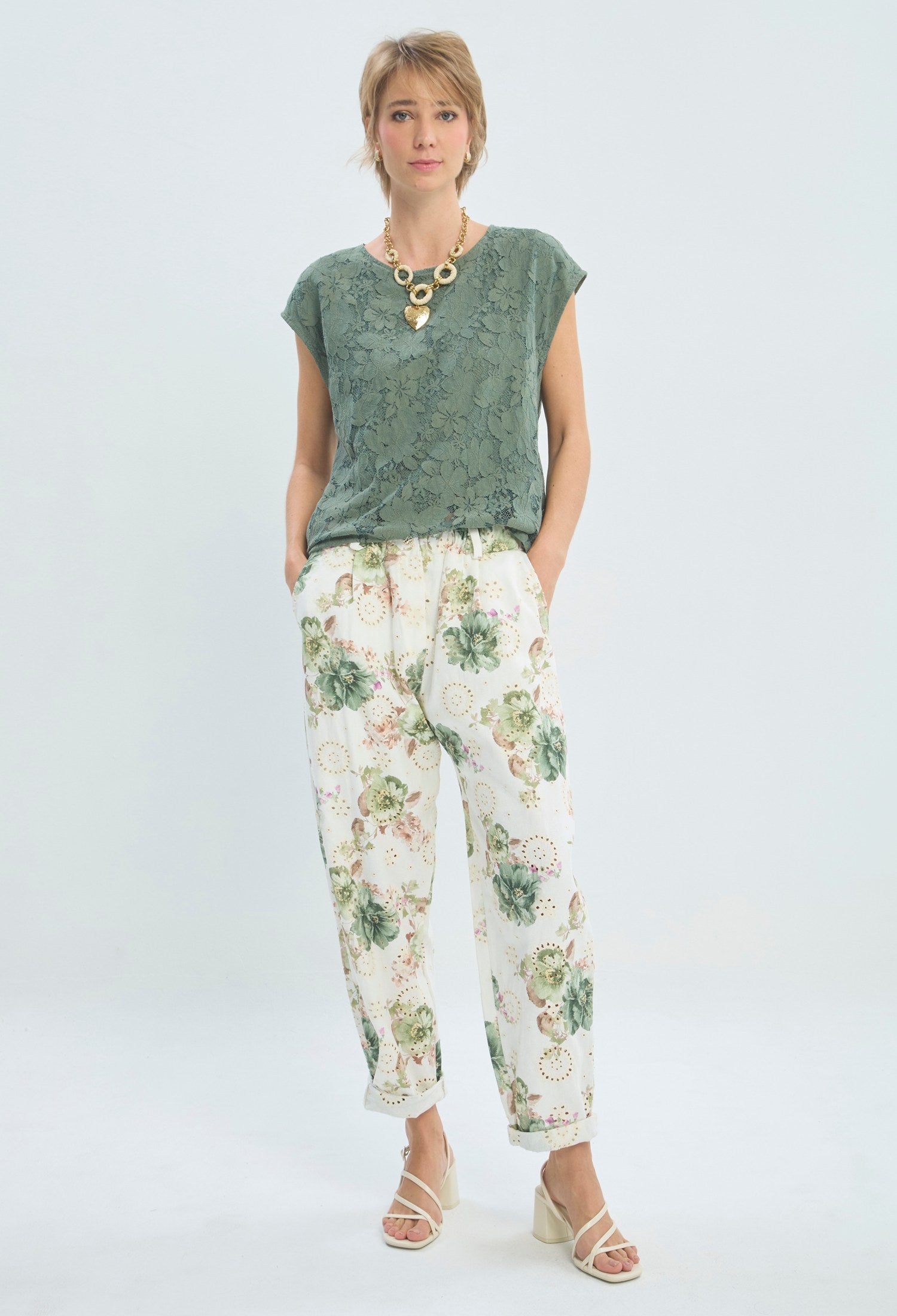 Pantalón floral con ojaletes bordados sobre fondo blanco